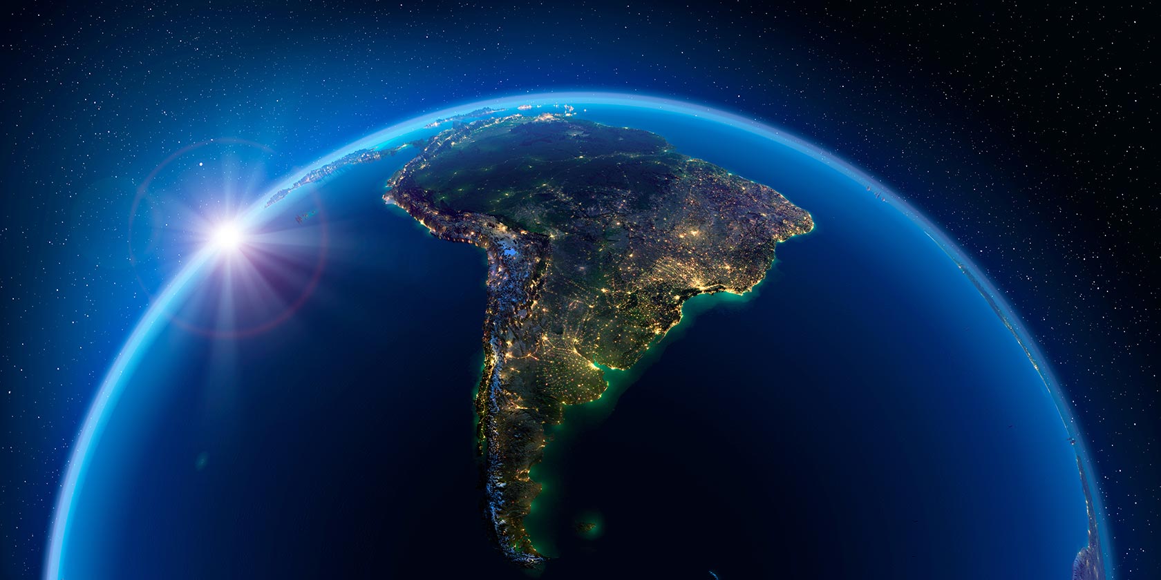 The Earth displaying South America against the night sky with the sun coming up. 